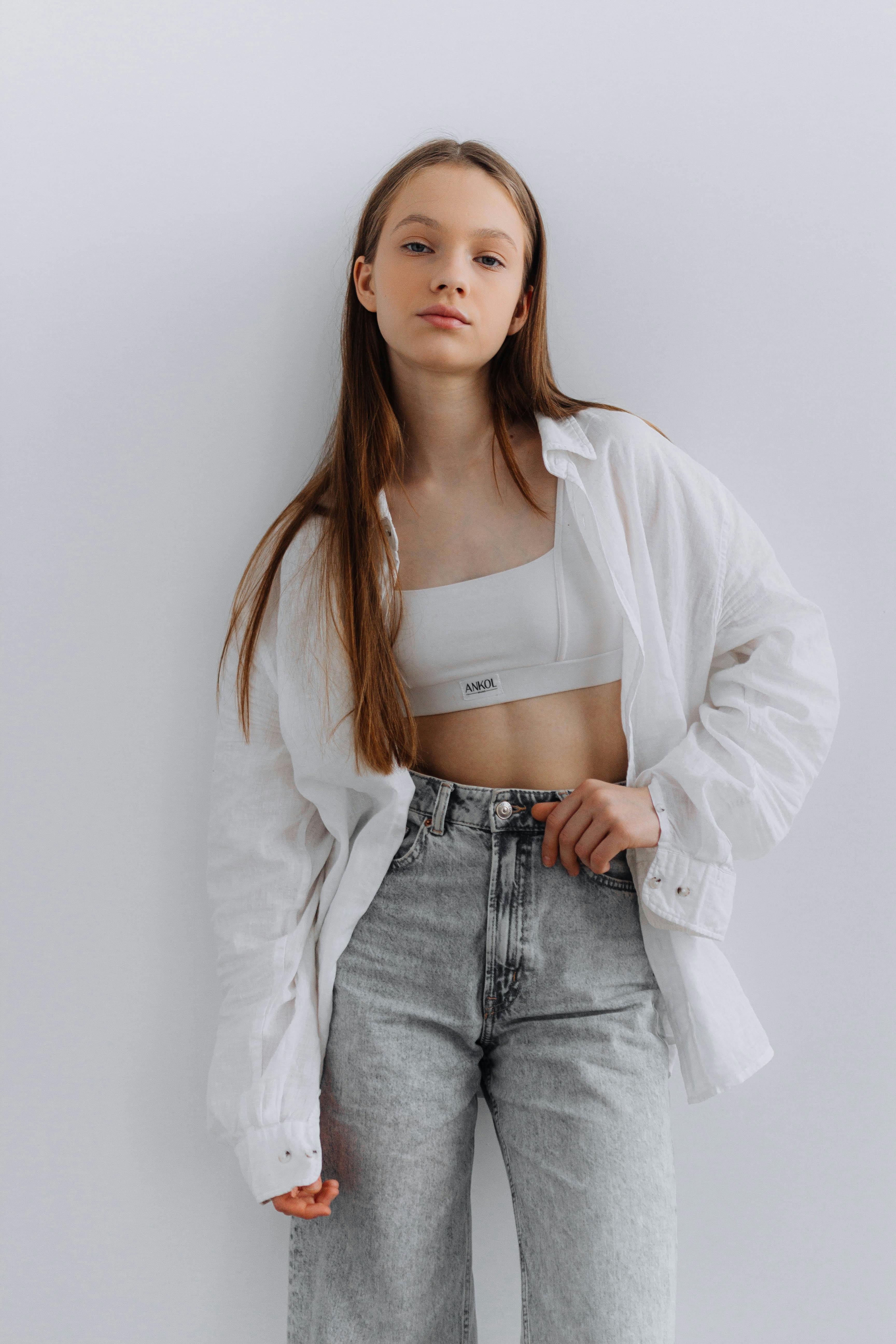 girl in a white linen shirt and crop top representing the Clean Girl aesthetic style