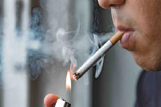 A man lighting up a cigarette